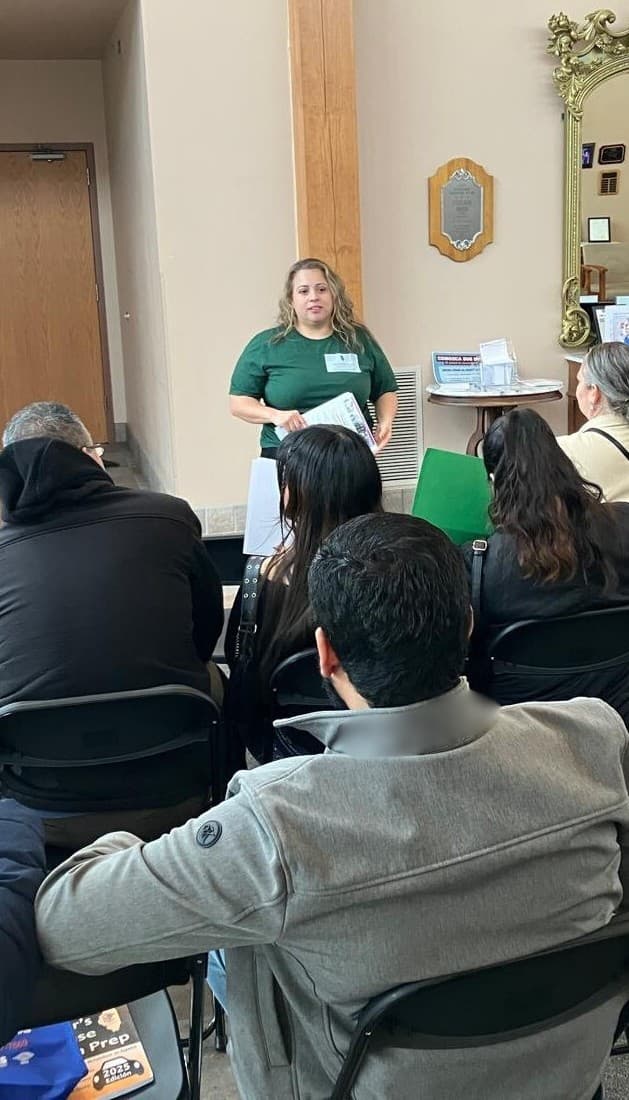 A FLAP staff member speaks to a seated audience at a community know-your-rights session.